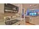 Bright kitchen with appliances, granite countertops, and view to living room at 2700 N Peninsula Ave # 113, New Smyrna Beach, FL 32169