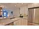 Open concept kitchen with stainless steel refrigerator and granite countertops at 2700 N Peninsula Ave # 113, New Smyrna Beach, FL 32169