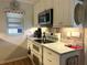 Updated kitchen with white cabinets, stainless steel appliances, and tile backsplash at 2700 N Peninsula Ave # 113, New Smyrna Beach, FL 32169
