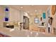Bright kitchen with white cabinetry, stone countertops, and stainless steel appliances at 2700 N Peninsula Ave # 113, New Smyrna Beach, FL 32169