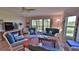 Comfortable living room with wicker furniture, ceiling fan, and sliding glass doors to the outside at 2700 N Peninsula Ave # 113, New Smyrna Beach, FL 32169