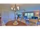 Living room and dining area with lots of light and access to outdoor balcony at 2700 N Peninsula Ave # 113, New Smyrna Beach, FL 32169