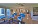 Open-concept living space with wicker furniture, ceiling fan, and access to the kitchen and dining area at 2700 N Peninsula Ave # 113, New Smyrna Beach, FL 32169