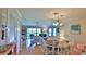 Open-concept living and dining area with lots of natural light and hardwood floors at 2700 N Peninsula Ave # 113, New Smyrna Beach, FL 32169