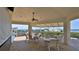 Covered outdoor patio with multiple tables and chairs, providing a comfortable space for dining and entertaining at 2700 N Peninsula Ave # 113, New Smyrna Beach, FL 32169