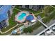 Aerial view of the community pool, lounge chairs, and dock with colorful kayaks at 2700 N Peninsula Ave # 113, New Smyrna Beach, FL 32169