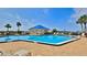 Bright blue community pool featuring a bar under a pavilion with lounge seating and mature palm trees at 2700 N Peninsula Ave # 113, New Smyrna Beach, FL 32169