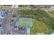 Aerial shot showcases the community's tennis courts surrounded by well-maintained landscaping and parking at 2700 N Peninsula Ave # 113, New Smyrna Beach, FL 32169