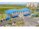 Attractive aerial view of the blue roof condo complex near beach with palm trees at 2700 N Peninsula Ave # 513, New Smyrna Beach, FL 32169