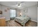 Bedroom with wood floors and natural light, plus a ceiling fan at 2700 N Peninsula Ave # 513, New Smyrna Beach, FL 32169
