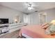 Bright bedroom with wood floors, ceiling fan, and ensuite bathroom at 2700 N Peninsula Ave # 513, New Smyrna Beach, FL 32169