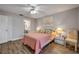Cozy bedroom with ceiling fan, wood floors, and an ensuite bathroom at 2700 N Peninsula Ave # 513, New Smyrna Beach, FL 32169
