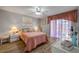 Bright bedroom with wood floors, ceiling fan, and a door to the outside at 2700 N Peninsula Ave # 513, New Smyrna Beach, FL 32169
