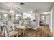 Open-concept dining area flows into a spacious kitchen, featuring a breakfast bar, and wood flooring at 2700 N Peninsula Ave # 513, New Smyrna Beach, FL 32169
