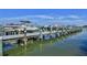 A long dock filled with various boats sits on calm water under a blue sky with scattered clouds at 2700 N Peninsula Ave # 513, New Smyrna Beach, FL 32169