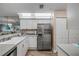 Bright kitchen with stainless steel refrigerator and ample counter space for cooking at 2700 N Peninsula Ave # 513, New Smyrna Beach, FL 32169