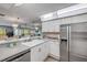 Spacious kitchen with double bowl sink and view into the living area at 2700 N Peninsula Ave # 513, New Smyrna Beach, FL 32169