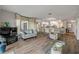Living area with wood flooring, comfortable furniture, and a mirrored wall at 2700 N Peninsula Ave # 513, New Smyrna Beach, FL 32169