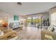 Inviting living area with balcony access, wood floors, and comfortable seating at 2700 N Peninsula Ave # 513, New Smyrna Beach, FL 32169