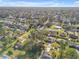 Aerial view of a residential neighborhood featuring well-maintained homes and verdant trees at 2828 Pine Tree Dr, Edgewater, FL 32141