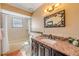 Bathroom featuring decorative framed mirror, granite countertop and shower over bathtub at 2828 Pine Tree Dr, Edgewater, FL 32141