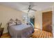 Bedroom featuring wood flooring, ceiling fan and window overlooking the backyard at 2828 Pine Tree Dr, Edgewater, FL 32141