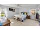 Bright and airy bedroom with a large window, ceiling fan, and neutral decor at 2828 Pine Tree Dr, Edgewater, FL 32141