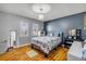 Bedroom featuring wood flooring and natural light from two windows at 2828 Pine Tree Dr, Edgewater, FL 32141