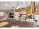 Bright kitchen featuring wood cabinets, granite countertops, and a modern stainless-steel sink at 2828 Pine Tree Dr, Edgewater, FL 32141