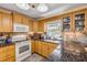 Well-lit kitchen with modern appliances, a mosaic backsplash, and ample cabinet space at 2828 Pine Tree Dr, Edgewater, FL 32141