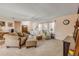Cozy living room featuring comfortable seating, a ceiling fan, and natural light from the windows at 2828 Pine Tree Dr, Edgewater, FL 32141