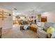 Comfortable living room featuring a neutral color palette and open layout to the kitchen and dining areas at 2828 Pine Tree Dr, Edgewater, FL 32141