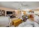 Spacious living room with built-in bookshelves and entertainment center, leading to an open kitchen area at 2828 Pine Tree Dr, Edgewater, FL 32141