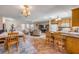 Open living space with a dining area, living room, and kitchen featuring tile floors and natural lighting at 2828 Pine Tree Dr, Edgewater, FL 32141