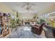Spacious sunroom with many windows, plants, cozy seating, and great natural lighting at 2828 Pine Tree Dr, Edgewater, FL 32141