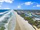 A distant aerial view of a beachfront home with beautiful ocean views and direct beach access at 2901 Hill St, New Smyrna Beach, FL 32169