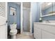 Cozy bathroom with blue walls, white fixtures, a shower, and a vanity for a clean and refreshing space at 2901 Hill St, New Smyrna Beach, FL 32169