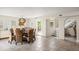 Open dining room with woven chairs and view of the staircase at 2901 Hill St, New Smyrna Beach, FL 32169