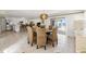 Bright dining room with large windows, woven chairs, and open flow to the kitchen at 2901 Hill St, New Smyrna Beach, FL 32169