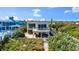 Back of beach house with a balcony overlooking manicured gardens with direct access to the beach at 2901 Hill St, New Smyrna Beach, FL 32169