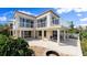 Elegant home exterior with a spacious balcony, outdoor seating, and a fire pit for a luxurious living experience at 2901 Hill St, New Smyrna Beach, FL 32169
