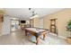 Spacious game room with pool table and view to the kitchenette at 2901 Hill St, New Smyrna Beach, FL 32169
