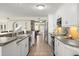Modern kitchen with white cabinetry, stainless steel appliances, and tiled floors at 2901 Hill St, New Smyrna Beach, FL 32169