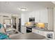 Well-lit kitchen features white cabinets and stainless steel appliances with views to other rooms at 2901 Hill St, New Smyrna Beach, FL 32169