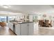 Bright, open concept kitchen with white cabinets, stainless appliances, a dining area, and an ocean view at 2901 Hill St, New Smyrna Beach, FL 32169