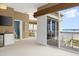 Spacious living area with a refreshment center and ocean views, leading to outdoor balcony at 2901 Hill St, New Smyrna Beach, FL 32169