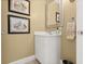 Well-lit powder room with modern fixtures, framed art, and convenient access for guests at 2901 Hill St, New Smyrna Beach, FL 32169