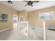 Bright hallway upstairs, with access to balcony and overlooking the staircase at 2901 Hill St, New Smyrna Beach, FL 32169