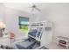 Bright bedroom featuring bunk beds and a window with a view, creating a cozy and functional space at 2908 Cypress Ridge Trl, Port Orange, FL 32128