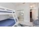 Bedroom with bunk beds, mirrored closet doors, and access to the adjacent laundry area for convenience at 2908 Cypress Ridge Trl, Port Orange, FL 32128